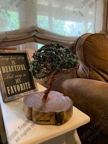 Wire tree sculpture displayed on a table in a home setting.