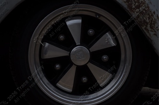 Close-up of a vintage Volkswagen wheel and chrome hubcap.