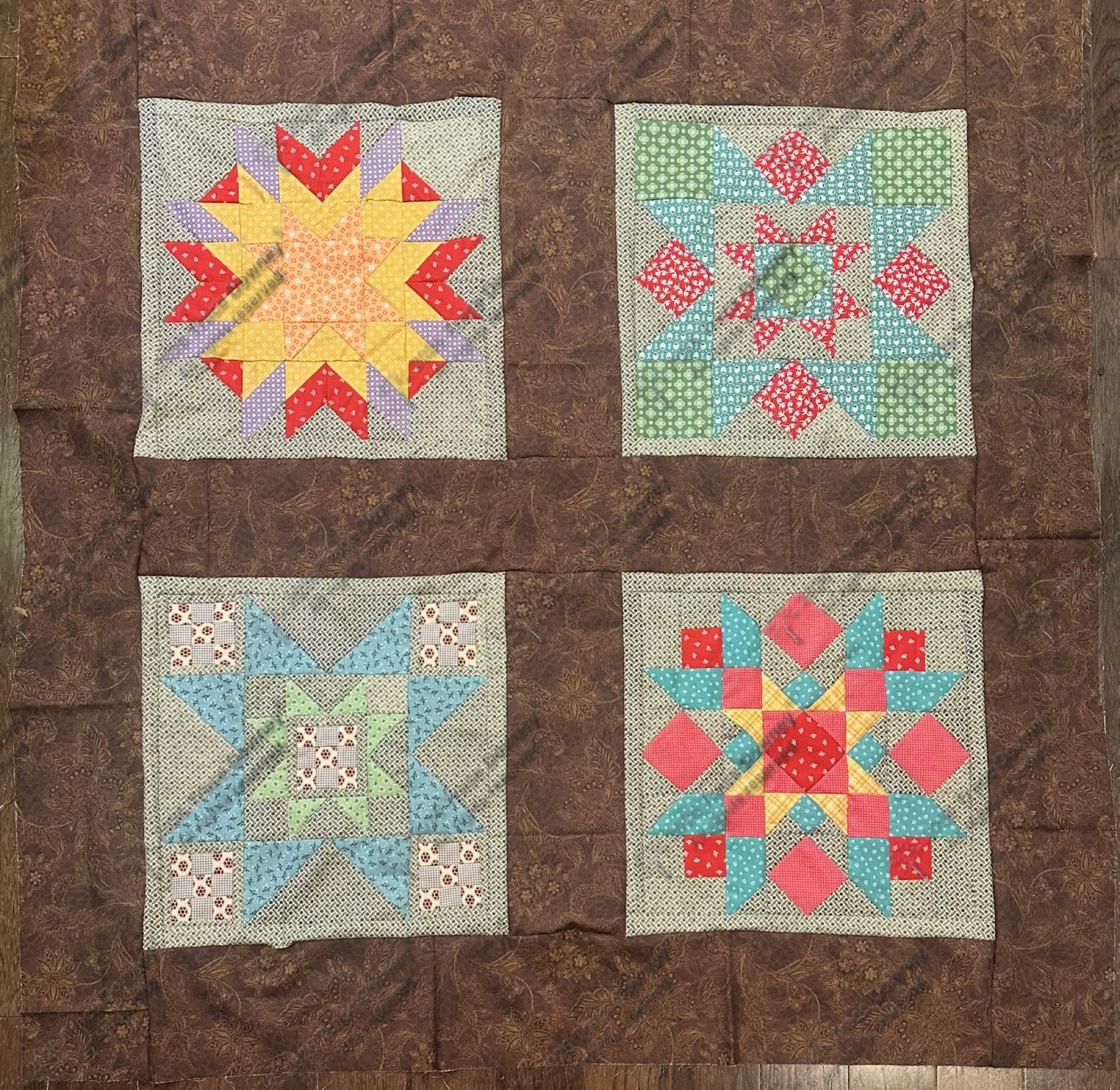 Four quilt blocks arranged in a square for a small composition study.