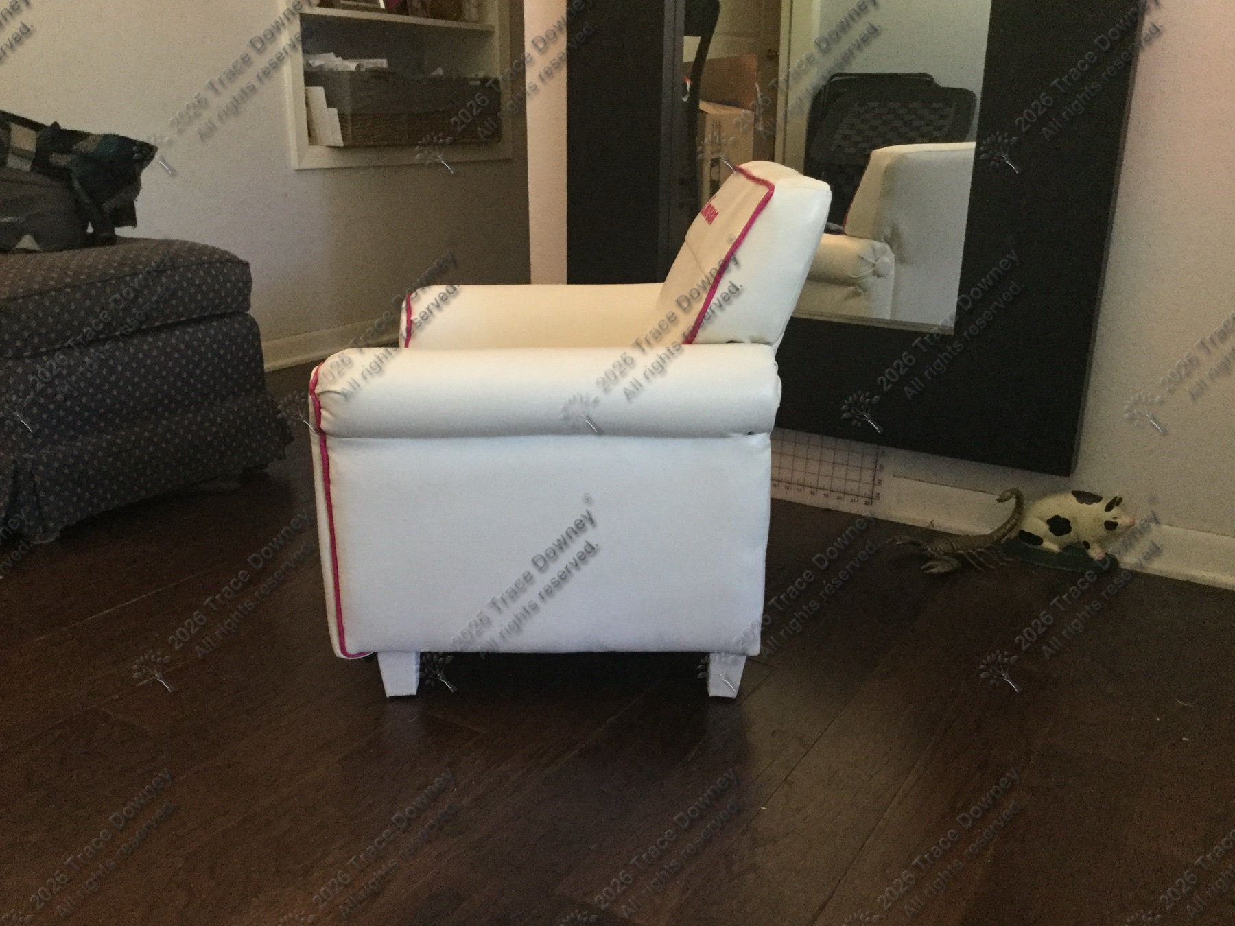 Side view of the finished white chair with red trim.